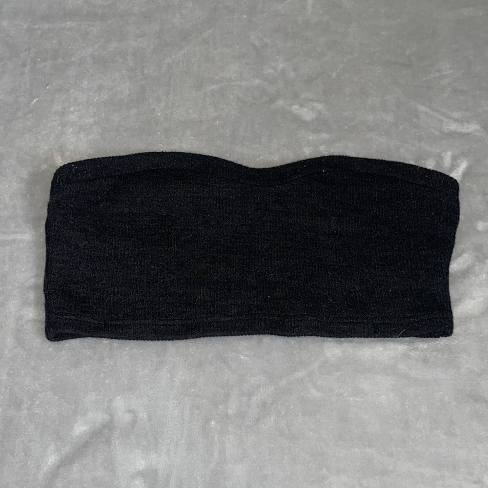 Knit fabric, linty tube top but comfortable and soft.